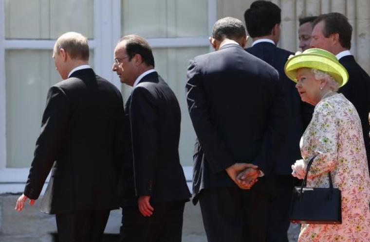 Russian President Vladimir Putin walks with French President Francois Hollande as U.S. President Barack Obama walks with Britain's Queen Elizabeth after a group photo for the 70th anniversary of the D-Day landings in Benouville June 6, 2014.