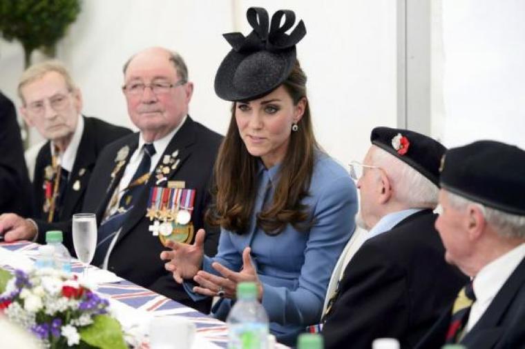 Britain's Catherine, the Duchess of Cambridge, (C) speaks to World War II veterans during the 70th French-American Commemoration D-Day Ceremony in Arromanches June 6, 2014.