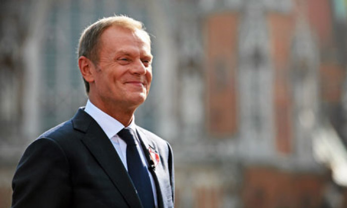 Polish prime minister Donald Tusk smiles at his supporters during election rally in Krakow.
