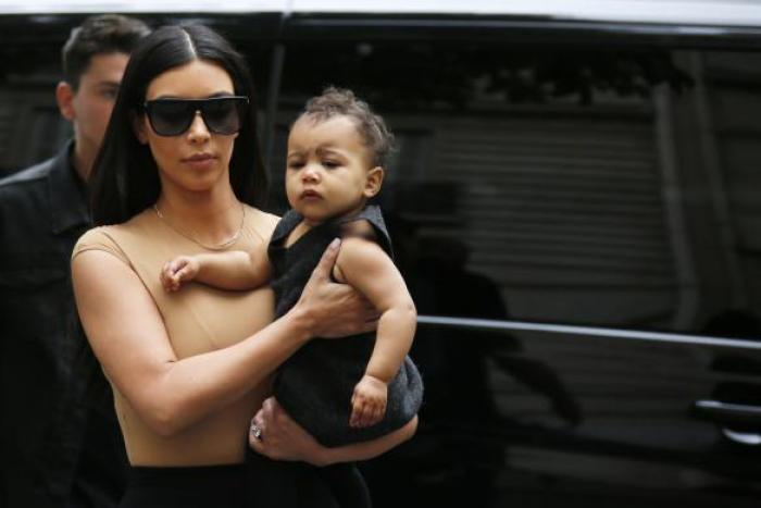 Kim Kardashian carries North West in Paris