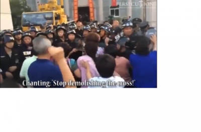 Christians in Wenzhou City, China, attempting to stop the forcible demolition of a church cross on June 11, 2014.