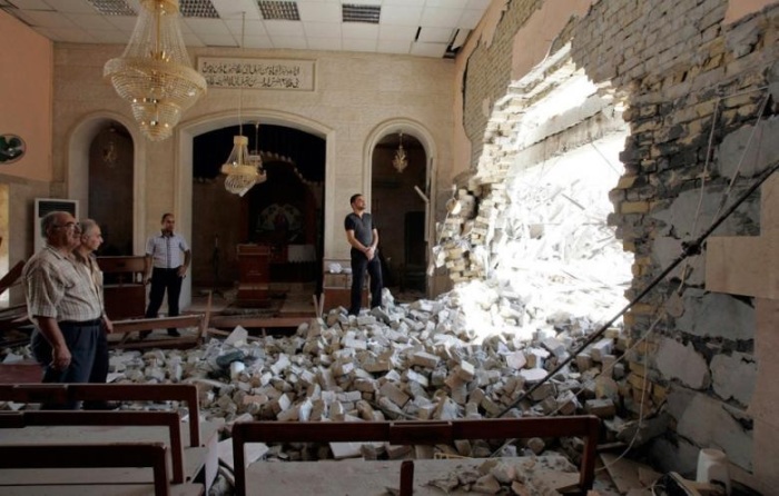 Residents inspect a damaged church after a bomb attack in central Kirkuk - August - 2011.