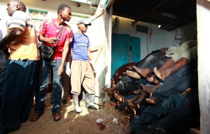 Residents look at the dead left behind after a terrorist attack in Mpeketoni, Kenya.