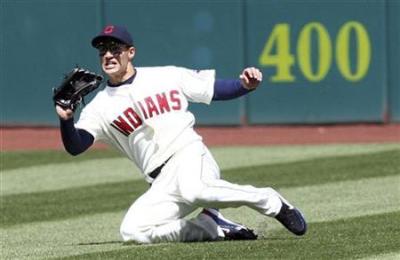 Cleveland Indians Grady Sizemore makes a sliding catch off a hit from Toronto Blue Jays Alex Rios during the second inning of their MLB American League baseball game in Cleveland, Ohio April 11, 2009.