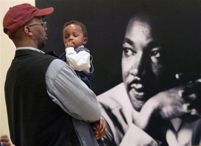 Brendon Barclay holds son Bryce as he visits the Morehouse College Martin Luther King Jr. collection at the Atlanta History Center which opened on the King Holiday in Atlanta, Georgia, Jan. 15, 2007.