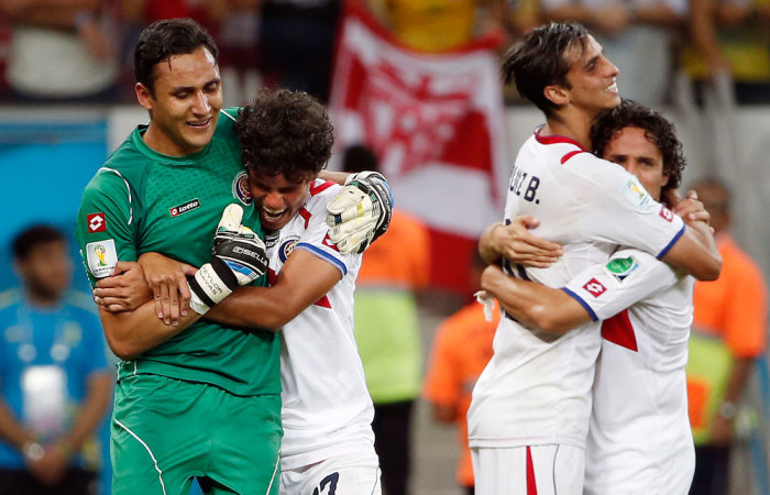 Costa Rica midfielder Yeltsin Tejeda (17) hugs Costa Rica goalkeeper Keylor Navas (1) after they defeated Greece during penalty kicks in a World Cup game at Arena Pernambuco.