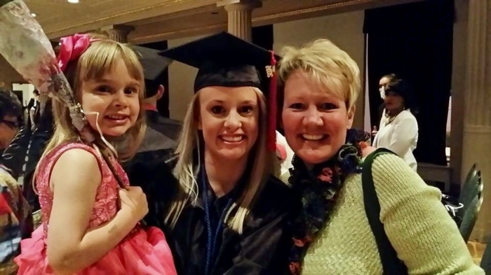 Katie alongside one of her daughters and Erin Stevens during her graduation in May.