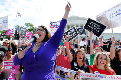 Kristan Hawkins of Students for Life leads anti-abortion demonstrators as they cheer after the ruling for Hobby Lobby was announced outside the U.S. Supreme Court in Washington June 30, 2014. The U.S. Supreme Court on Monday ruled that business owners can object on religious grounds to a provision of U.S. President Barack Obama's healthcare law that requires closely held companies to provide health insurance that covers birth control.