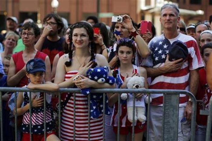 The Haig family stands for the United States pledge of allegiance before a public reading the United States Declaration of Independence, part of Fourth of July Independence Day celebrations, in Boston, Massachusetts, July 4, 2013.