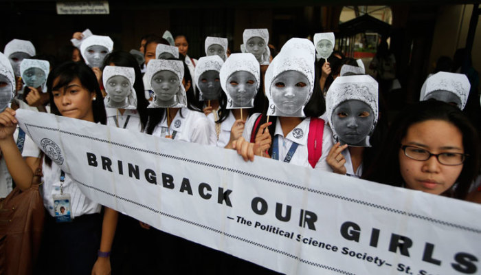 Students from an all-girls Catholic school, St Scholastica's College, wear masks depicting kidnapped African school girls in Manila, June 27, 2014. More than 1,000 girls took part in the protest outside their campus aimed at voicing outrage over the kidnapping of more than 200 girls from a school in northeast Nigeria in April by Boko Haram militants, a school official said.