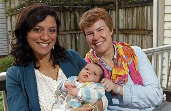 Valeria Tanco (L), and Sophy Jesty pose with their new baby girl, Emilia, at their home in Knoxville, Tennessee April 7, 2014.