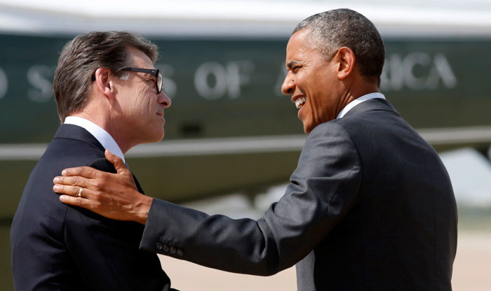 U.S. President Barack Obama (R) is greeted by Texas Governor Rick Perry upon Obama's arrival in Dallas to discuss a surge of Latin American young people crossing the U.S.-Mexico border July 9, 2014. Congressional Republicans on Wednesday cast a skeptical eye on a White House request for .7 billion to address an influx of child migrants at the U.S. border while Obama met with top critic Perry. Obama is battling political pressure from supporters and opponents alike to halt a growing humanitarian crisis along the Texas border with Mexico.