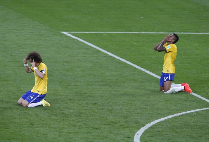 Brazil's David Luiz (L) and Luiz Gustavo react after losing their 2014 World Cup semi-finals against Germany at the Mineirao stadium in Belo Horizonte July 8, 2014.