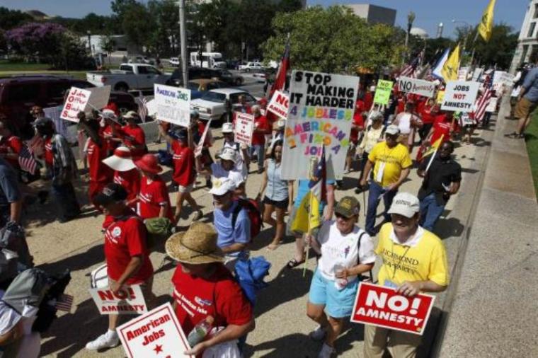 Demonstrators march against amnesty for illegal aliens, during a rally against the immigration reform bill in Pennsylvania Avenue in Washington, D.C. July 15, 2013.