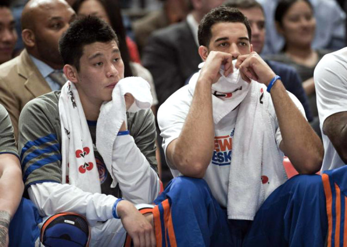 New York Knicks guards Jeremy Lin and Landry Fields (R) sit on the bench as they play the Indiana Pacers in the second quarter of their NBA basketball game at Madison Square Garden in New York City on March 16, 2012.