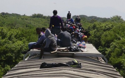 Unaccompanied minors ride atop the wagon of a freight train, known as La Bestia (The Beast) in Ixtepec, in the Mexican state of Oaxaca, June 18, 2014.