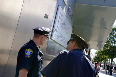 Boston police officers stand in front of a Planned Parenthood clinic in Boston, Massachusetts, June 28, 2014.