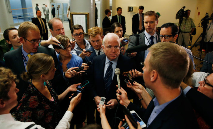Senate Armed Services Committee member Senator John McCain (R-AZ) (C) talks to media after departing a closed hearing on Iraq and Afghanistan in Washington July 8, 2014.