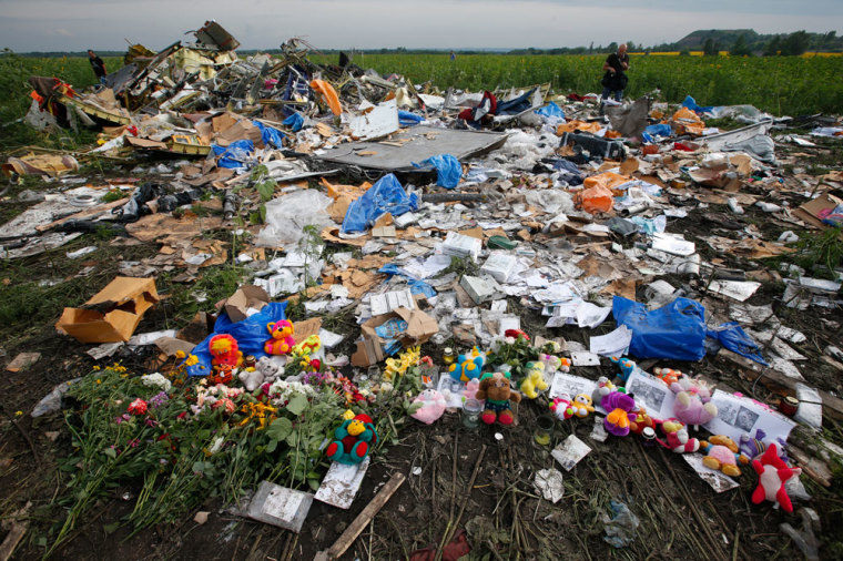Flowers and mementos placed at the crash site of Malaysia Airlines Flight MH17 are pictured near the settlement of Rozspyne in the Donetsk region July 19, 2014. Ukraine accused Russia and pro-Moscow rebels on Saturday of destroying evidence to cover up their guilt in the shooting down of the Malaysian airliner that has accelerated a showdown between the Kremlin and Western powers.