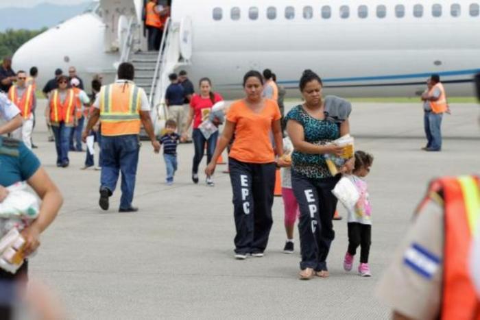 Women and their children walk on the tarmac after being deported from the U.S., at the Ramon Villeda international airport in San Pedro Sula, in this July 14, 2014 handout provided by the Honduran Presidential House.