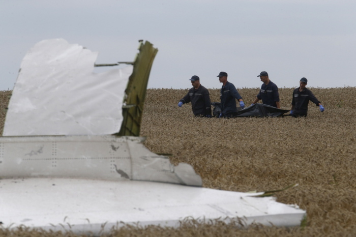 Members of the Ukrainian Emergency Ministry carry a body at the crash site of Malaysia Airlines Flight MH17, near Grabovo in the Donetsk region of Ukraine on July 19, 2014.