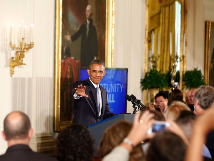 U.S. President Barack Obama waves before he signs an Executive Order to protect LGBT employees from workplace discrimination while in the East Room at the White House in Washington, July 21, 2014.