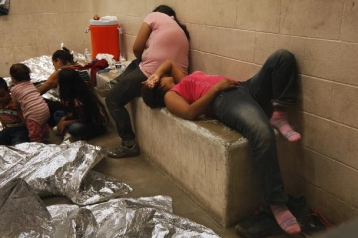 Immigrants who have been caught crossing the border illegally are housed inside the McAllen Border Patrol Station in McAllen, Texas, July 15, 2014, where they are processed.