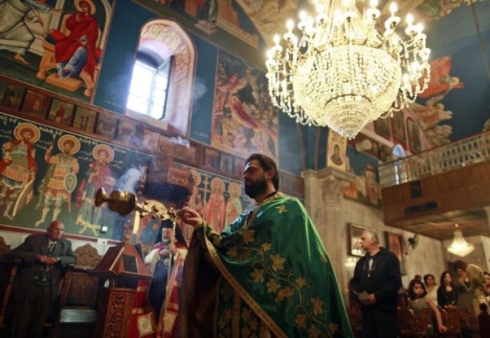 A member of the Orthodox clergy takes part in a Palm Sunday mass at the Saint Porfirios church in Gaza City April 8, 2012.
