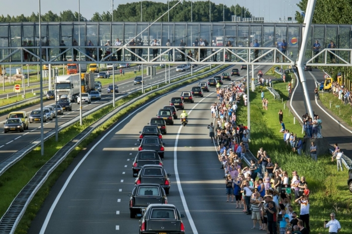 A convoy of hearses, bearing remains of the victims of the Malaysia Airlines Flight MH17 crash, are escorted along the A27 highway by military police.