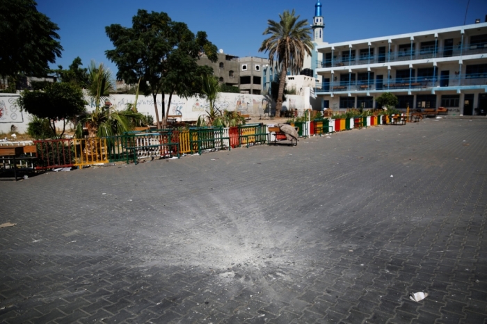 A crater marks the centre of a courtyard at a United Nations-run school sheltering Palestinians displaced by an Israeli ground offensive, that police said was hit by an Israeli shell, in Beit Hanoun in the northern Gaza Strip July 24, 2014. At least 15 people were killed and many wounded on Thursday when Israeli forces shelled a U.N.-run school sheltering Palestinian refugees in northern Gaza, said a spokesman for the Gaza health ministry, Ashraf al-Qidra. Chris Gunness, spokesman for the main U.N. agency in Gaza UNRWA, confirmed the strike and criticised Israel. The Israel army had no immediate comment on the reports. Hamas fired rockets at Tel Aviv and said its gunmen carried out a lethal ambush on Israeli soldiers in north Gaza.