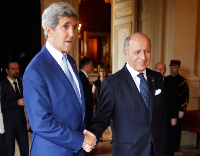 U.S. Secretary of State John Kerry (L), is greeted by France's Foreign Minister, Laurent Fabius, in Paris July 26, 2014.