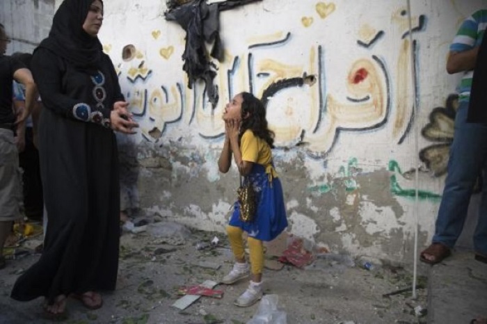 A Palestinian girl reacts at the scene of an explosion that medics said killed eight children and two adults, and wounded 40 others at a public garden in Gaza City July 28, 2014.