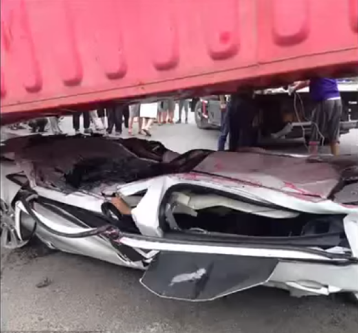 A truck dropped a shipping container on a car in China July 26, 2014, crushing the two occupants, but they miraculously survived.