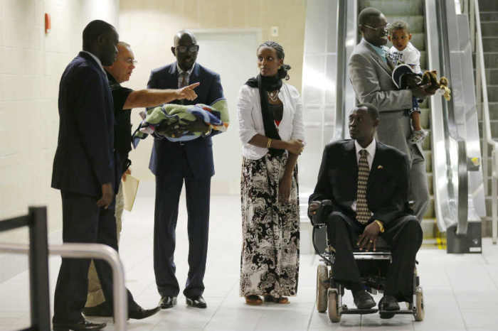 Mariam Yahya Ibrahim (C) arrives at the airport in Manchester, New Hampshire with family members, including her husband Daniel Wani (2nd R) and his brother Gabriel Wani (R), July 31, 2014.