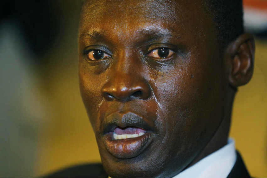 The face of Daniel Wani is streaked with tears as he speaks to reporters after his wife Mariam Yahya Ibrahim arrived at the airport in Manchester, New Hampshire July 31, 2014.