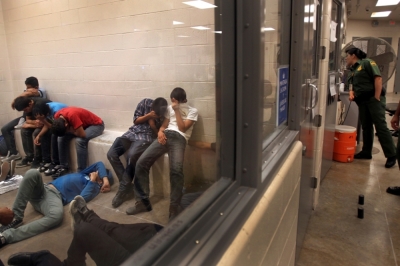 Immigrants who have been caught crossing the border illegally are housed inside the McAllen Border Patrol Station in McAllen, Texas, July 15, 2014.