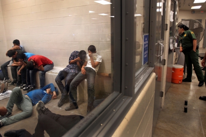 Immigrants who have been caught crossing the border illegally are housed inside the McAllen Border Patrol Station in McAllen, Texas, July 15, 2014, where they are processed. More than 57,000 unaccompanied children have been apprehended at the southwestern border since October, more than twice the total this time last year.