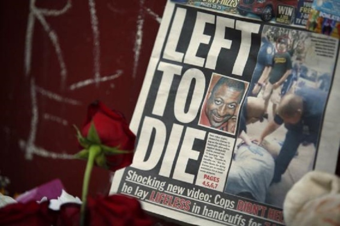 A picture of Eric Garner is seen on a newspaper at his memorial in Staten Island, New York, July 21, 2014. Garner, suspected of selling untaxed cigarettes, died after New York police put him in a chokehold. The cause of Garner's death is still being determined by the city's medical examiner.