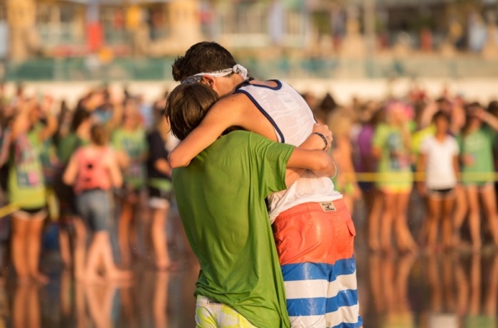 Two friends embrace one other after getting baptized during The Gauntlet summer camp in Daytona Beach, Fla.