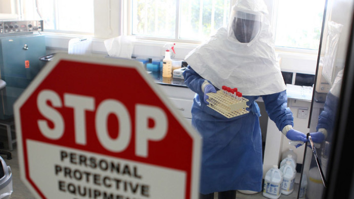 A health worker collects samples of the Ebola virus at the Centre for Disease Control in Entebble.