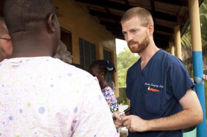 Dr. Kent Brantly (R) speaks with colleagues at the case management center on the campus of ELWA Hospital in Monrovia, Liberia in this undated handout photograph courtesy of Samaritan's Purse.
