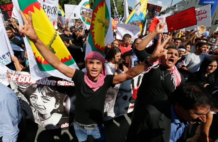 Kurds of the ethnic minority of Yazidis march through the streets of Bielefeld August 9, 2014. Some 10,000 ethnic Kurds of the Yazidis sect, who practice an ancient faith related to Zoroastrianism, protested in the western German city on Saturday against Islamic State (IS) militants, who are surging across northern Iraq near the Kurdistan borders in their drive to eradicate unbelievers such as Christians and Yazidis.