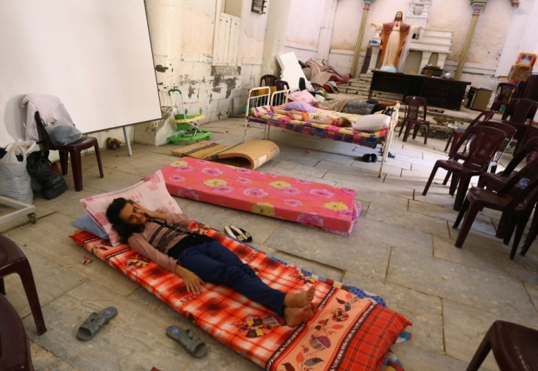An Iraqi Christian family fleeing the violence in the Iraqi city of Mosul, sleeps inside the Sacred Heart of Jesus Chaldean Church in Telkaif near Mosul, in the province of Nineveh, July 20, 2014.