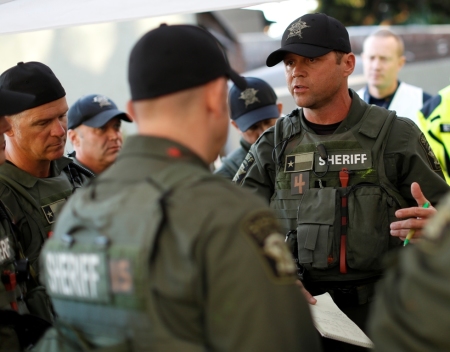 The Texas Travis County Sherrif's Office SWAT Team prepare a plan to secure a simulated barricade terrorist at a hospital scenario at Urban Shield 2013 in Oakland, California, October 26, 2013.