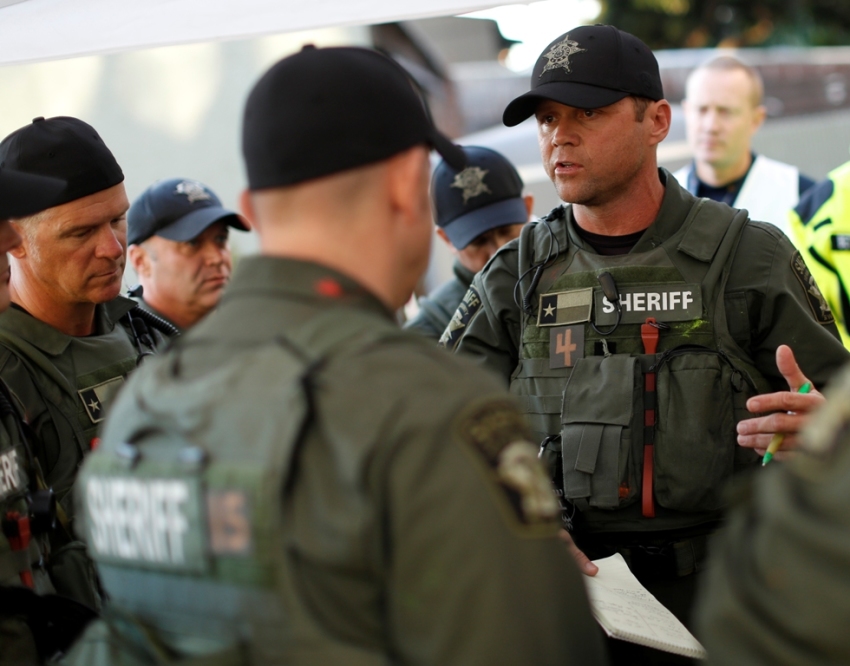 The Texas Travis County Sherrif's Office SWAT Team prepare a plan to secure a simulated barricade terrorist at a hospital scenario at Urban Shield 2013 in Oakland, California, October 26, 2013.