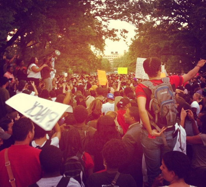 People gather for a National Moment of Silence peace vigil after unarmed teen Michael Brown was shot by a police officer in Ferguson, Missouri, in Washington, D.C., on Thursday, August, 14, 2014.