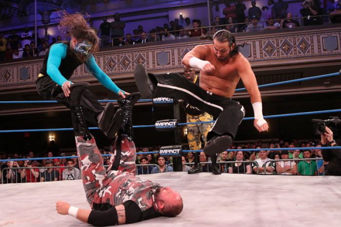 Tag team match pitting the Hardys versus Team 3D in August 2014 in New York City. Jeff Hardy (left) and his brother Matt (right) double team Bully Ray (on back) as Devon looks on in the background.