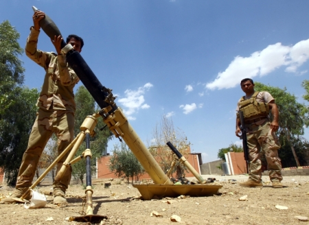 Kurdish "peshmerga" troops prepare to fire a mortar during an intensive security deployment against Islamic State militants on the outskirts of the province of Nineveh, Aug. 6, 2014. Islamic State militants extended their gains in northern Iraq on Thursday, seizing three more towns and gaining a foothold near the Kurdish region, witnesses said. The advance came after the Sunni militants inflicted a humiliating defeat on Kurdish forces in a weekend sweep in the north. The Islamic State, which has declared a caliphate in parts of Iraq and Syria it controls, clashed with Kurdish forces on Wednesday in the town of Makhmur near Arbil, the capital of the Kurdish semi-autonomous zone.