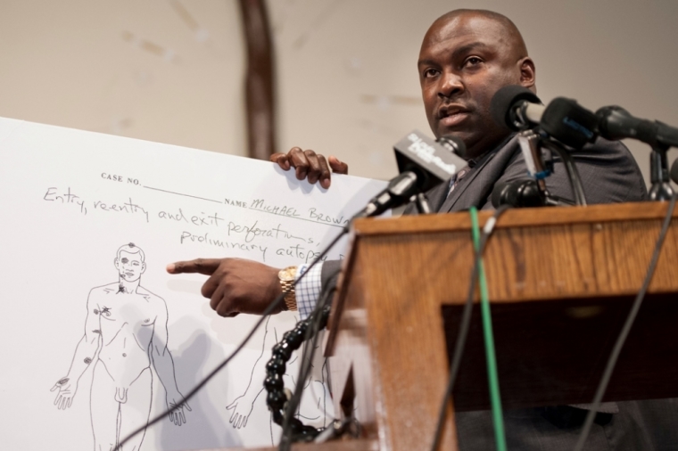 Brown family attorney Daryl Parks points on an autopsy diagram, on Aug. 18, 2014, to one of the wounds Michael Brown sustained when he was shot by the police. The family of Michael Brown, an 18-year-old teenager shot dead by a police officer in Ferguson, Missouri, paid for an independent autopsy which was carried out by Dr. Michael Baden, former chief medical examiner for the City of New York.