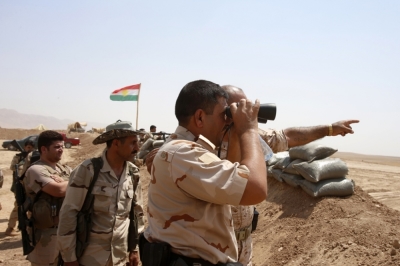 Kurdish Peshmerga fighters stand guard on the outskirts of Gwer town after Islamic State insurgents withdrew on Aug. 18, 2014.